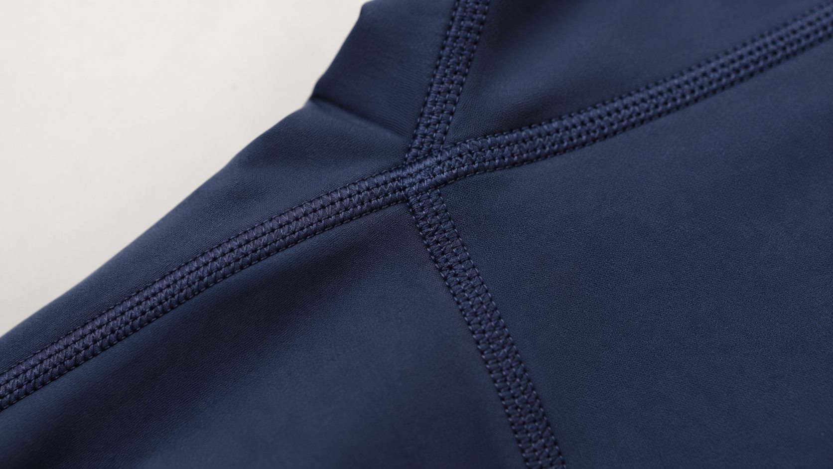 Close-up flatlock seam detail for activewear stitching quality control